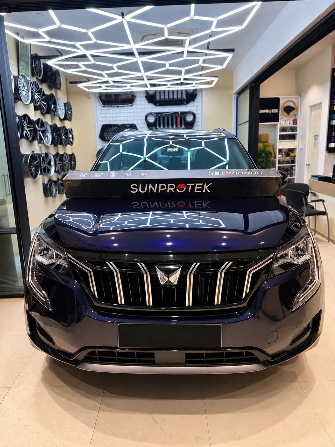 Front view of a Mahindra XUV 700 with SunProtek PPF packaging on the bonnet