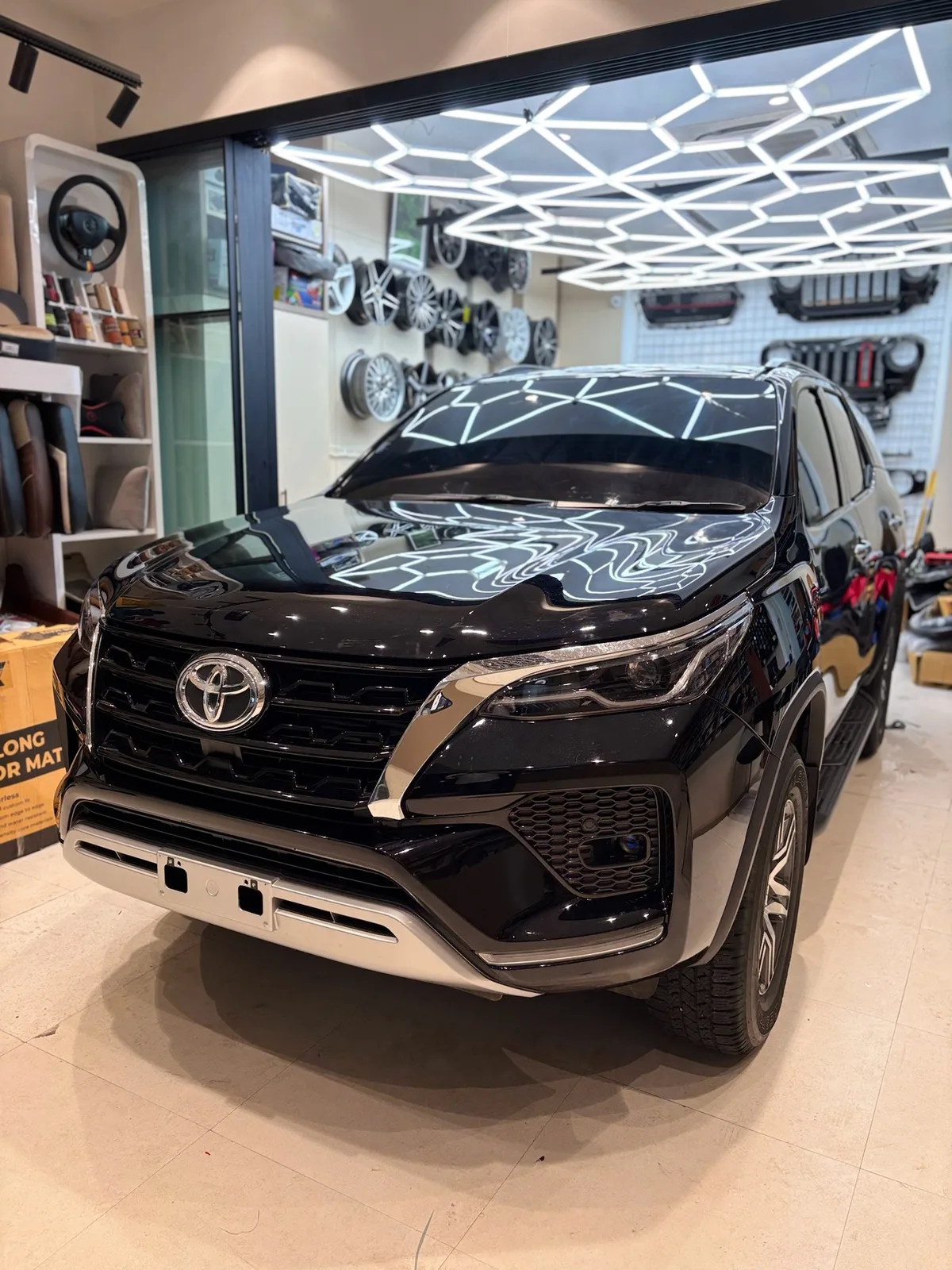 Front right angle of a black Fortuner after PPF fitting