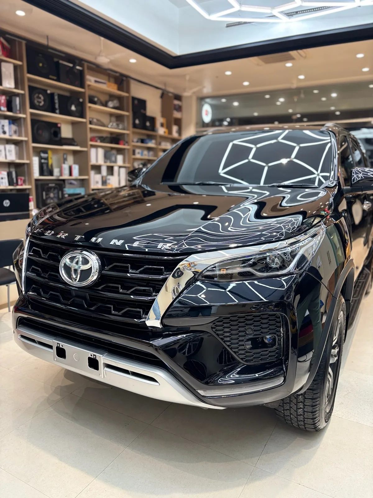 Black Fortuner with PPF inside the fitting studio